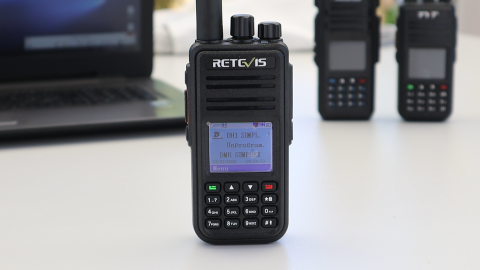 Handheld digital mobile radio with antenna, display screen, keypad, and control knobs